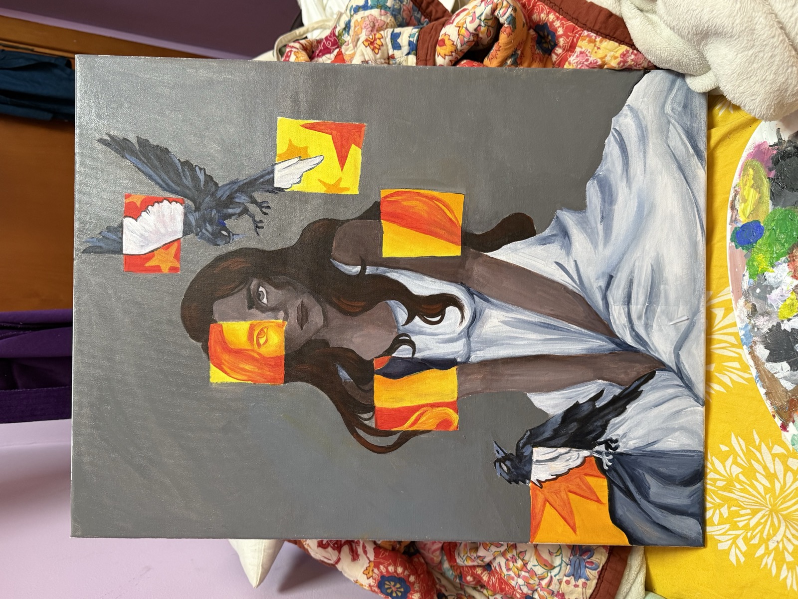 Ravens and Fire — large acrylic canvas depicting a seated woman in white with ravens and geometric orange-yellow shapes